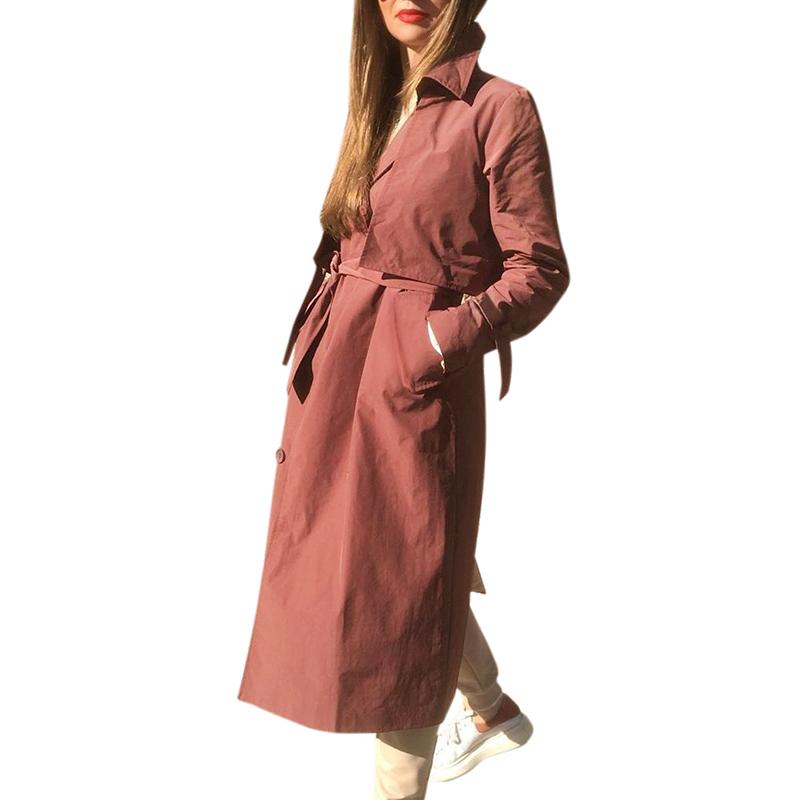 Women’s long brick red trench coat by Jade, V-neck windbreaker jacket with tied waist, suitable for gentle wind protection.