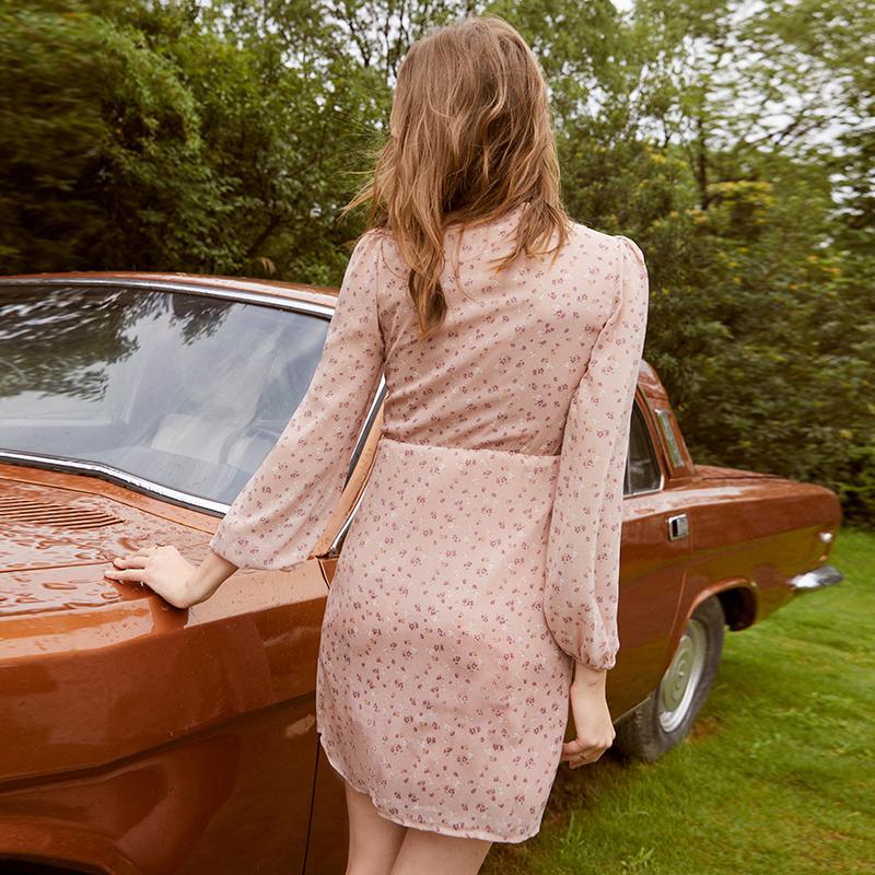 Pink floral ruched women’s dress by Jade featuring V-neck, pearl buttons, long sleeves, and a chic, feminine design.