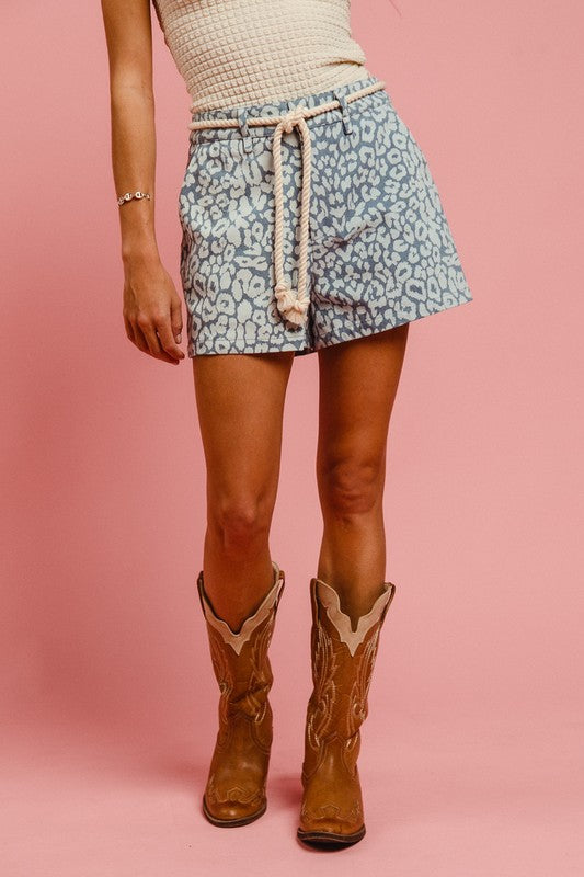 Leopard print BiBi Rope Belt from Jade Icarus styled with automotive-themed accessories on the shorts.