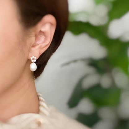 Fuchsia Hercules freshwater pearl drop earrings with elegant jewelry design, showcasing dangling pearls on silver hooks.