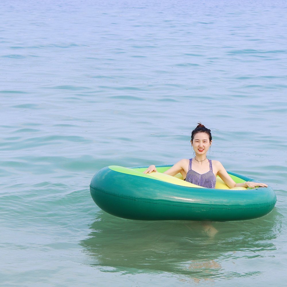 Maroon Asteria inflatable giant avocado pool float with green and brown design, perfect for swimming and relaxation in the pool.