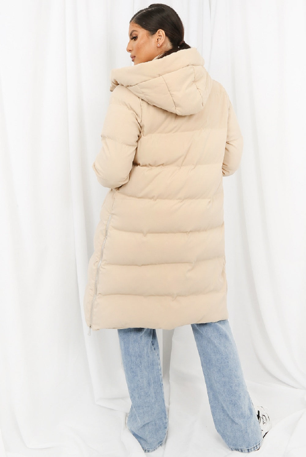 Beige hooded longline puffer coat by Rose Eleusis, stylish winter jacket with a quilted design and cozy hood.