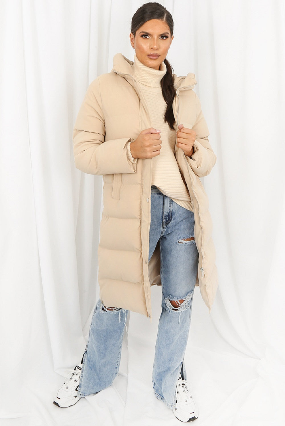 Beige hooded longline puffer coat by Rose Eleusis, featuring a cozy, insulated design and a stylish oversized fit.