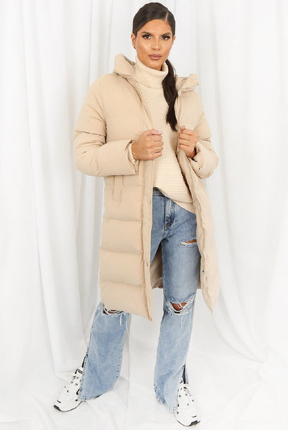Beige hooded longline puffer coat by Rose Eleusis, featuring a cozy, insulated design and a stylish oversized fit.