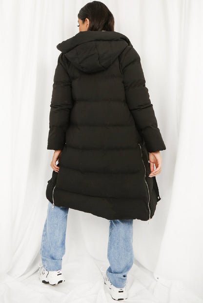 Black hooded longline puffer coat by Rose Eleusis, showcasing its padded design and cozy hood for winter warmth.