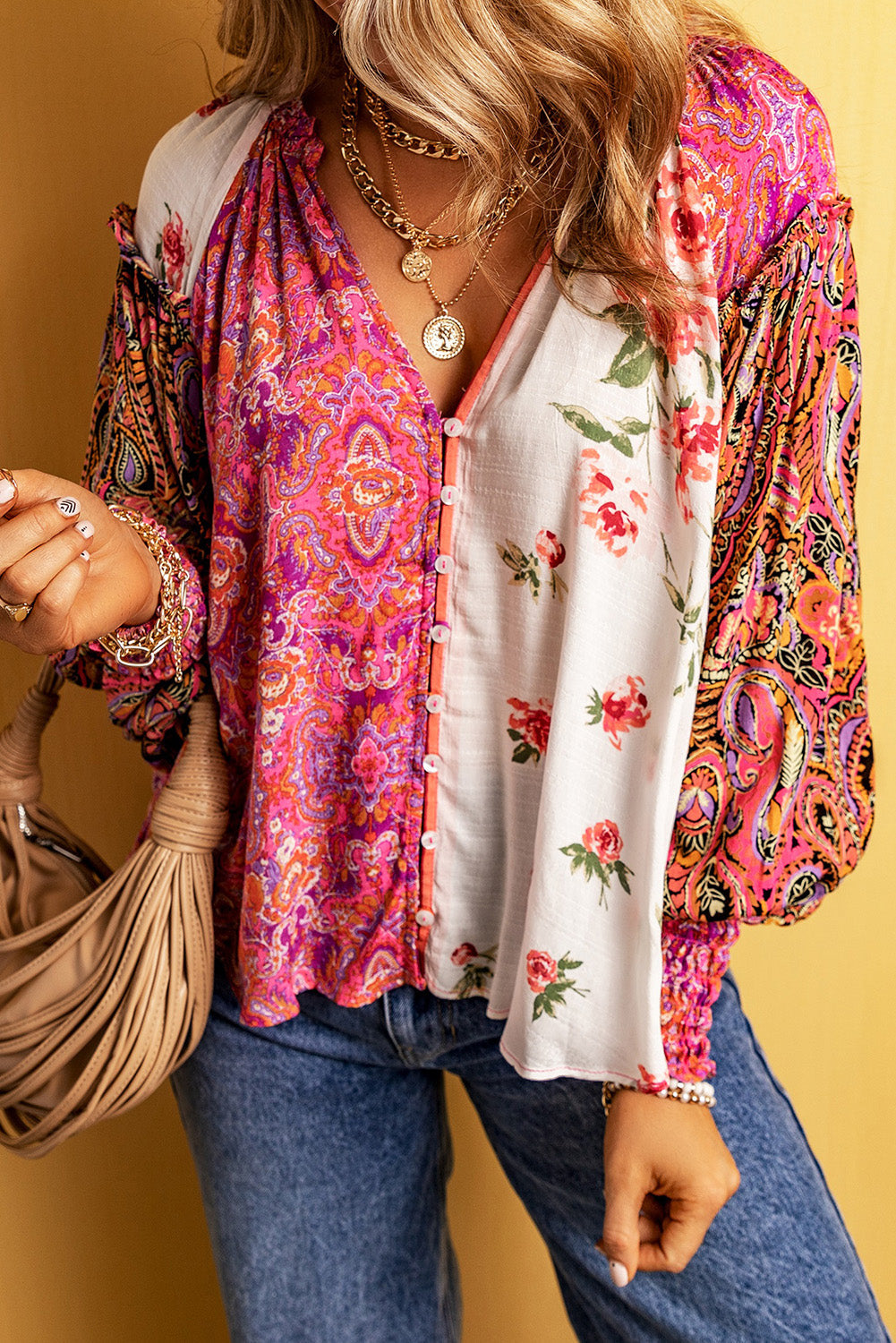 Multicolor floral patchwork blouse by Carmine Juneberry featuring a V-neck, shirred cuffs, and button closure.