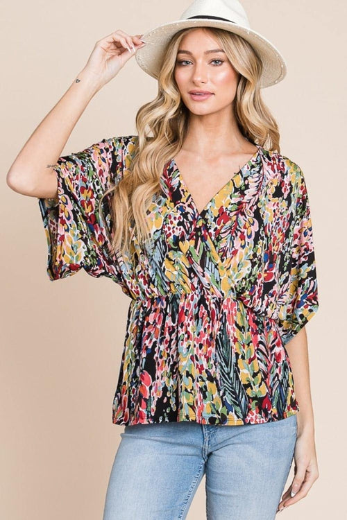 Carmine Juneberry BOMBOM printed surplice peplum blouse with long sleeves and floral pattern, styled on a mannequin.
