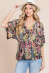 Carmine Juneberry BOMBOM printed surplice peplum blouse with long sleeves and floral pattern, styled on a mannequin.