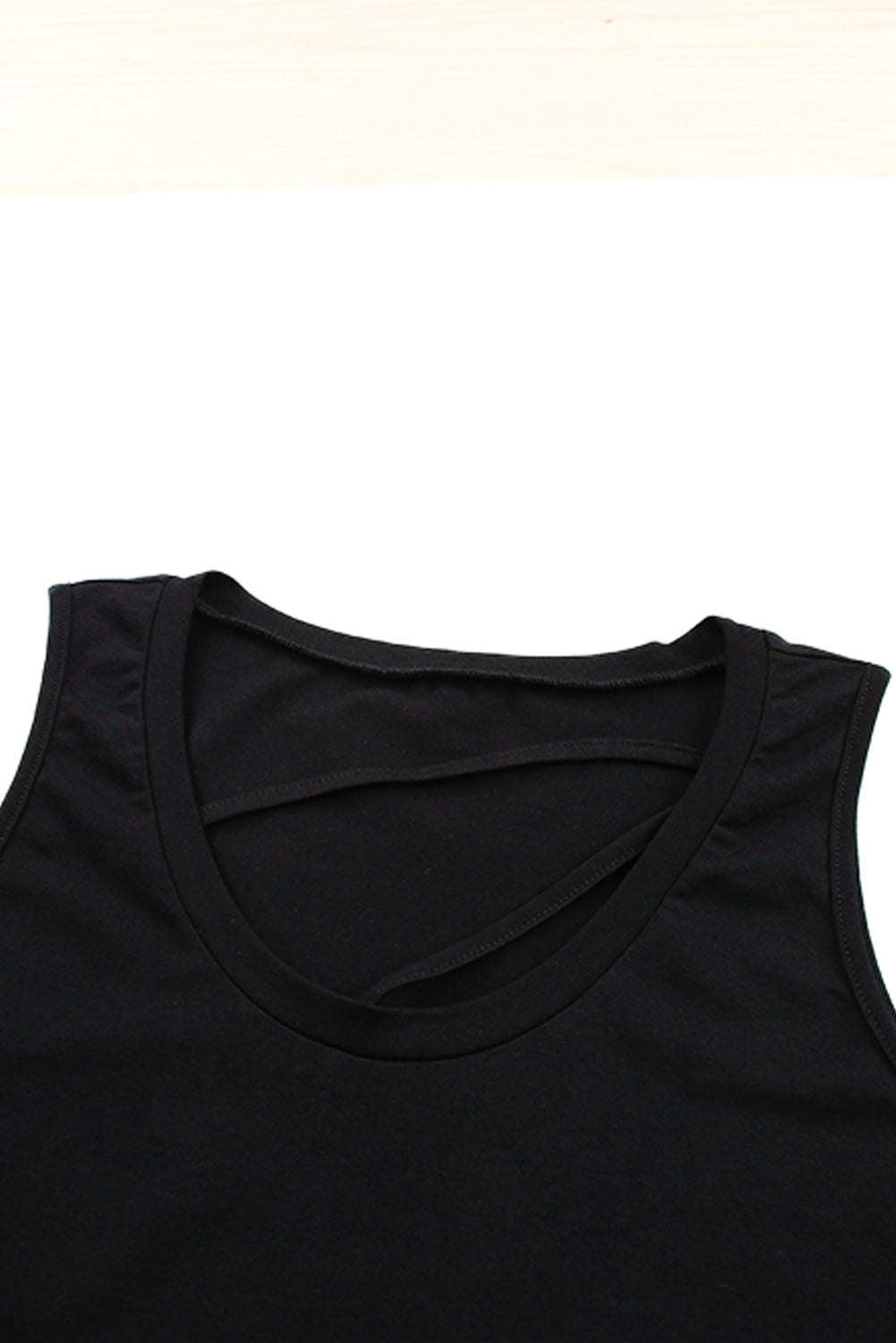 Black strappy hollow-out neck tank top by Harlequin Daisy, featuring a stylish cutout design and slim straps.