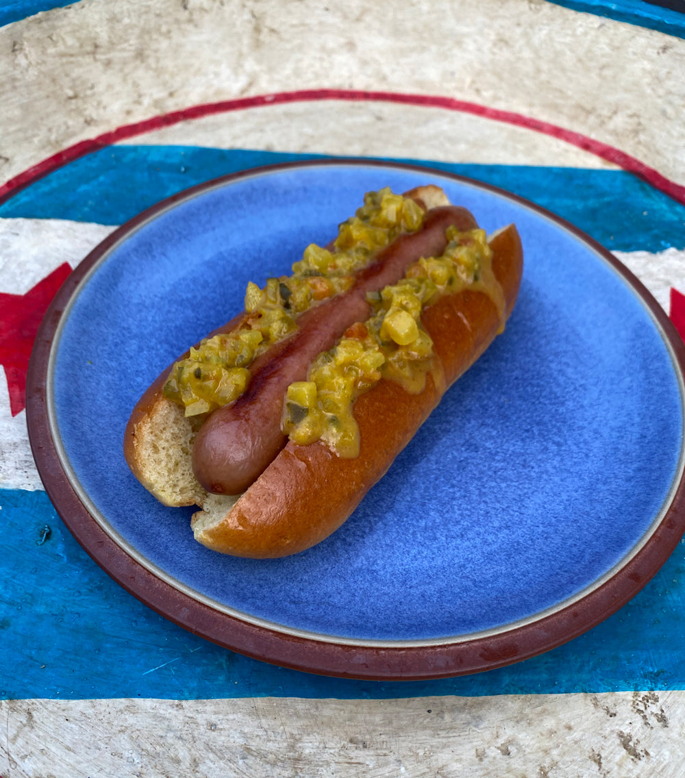 Start2Finish bacon hot dogs with crispy bacon slices on grilled hot dogs in a bun, ready to serve.
