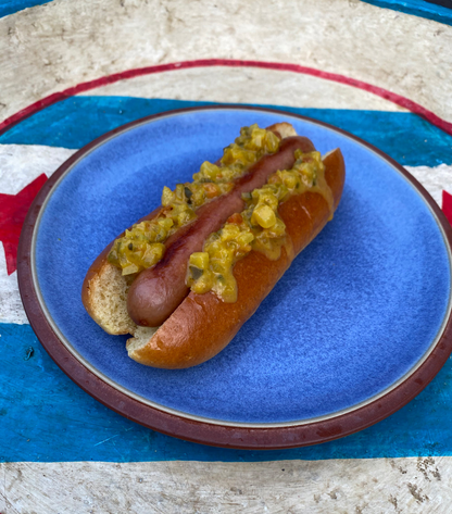 Start2Finish bacon hot dogs with crispy bacon slices on grilled hot dogs in a bun, ready to serve.
