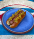 Start2Finish bacon hot dogs with crispy bacon slices on grilled hot dogs in a bun, ready to serve.