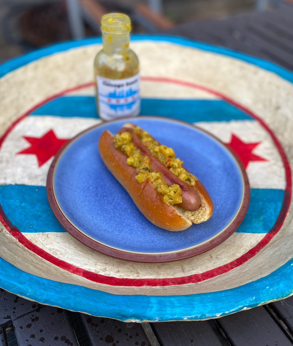 Start2Finish bacon hot dogs, grilled and topped with crispy bacon and condiments, served on a bun.