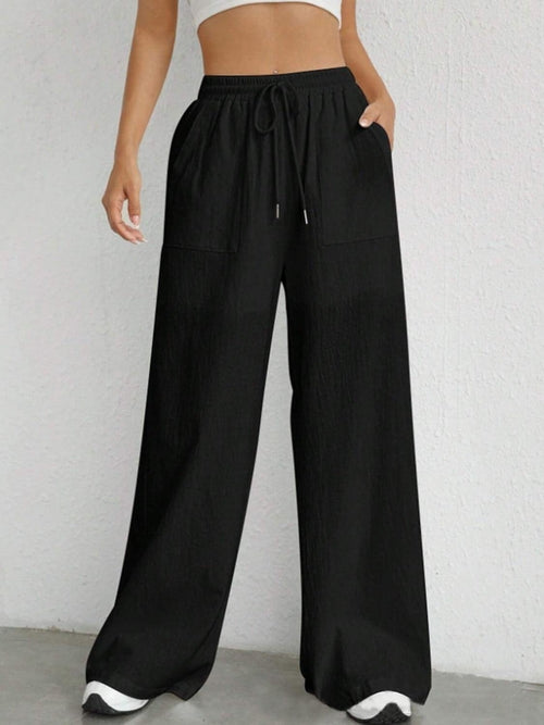 Carmine Juneberry drawstring wide leg pants in a relaxed fit with a high waist and flowing silhouette, shown in natural fabric.