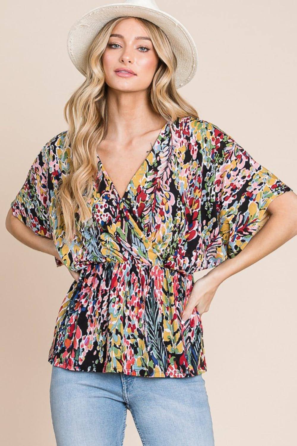 Carmine Juneberry BOMBOM printed surplice peplum blouse with long sleeves and floral pattern, styled on a mannequin.