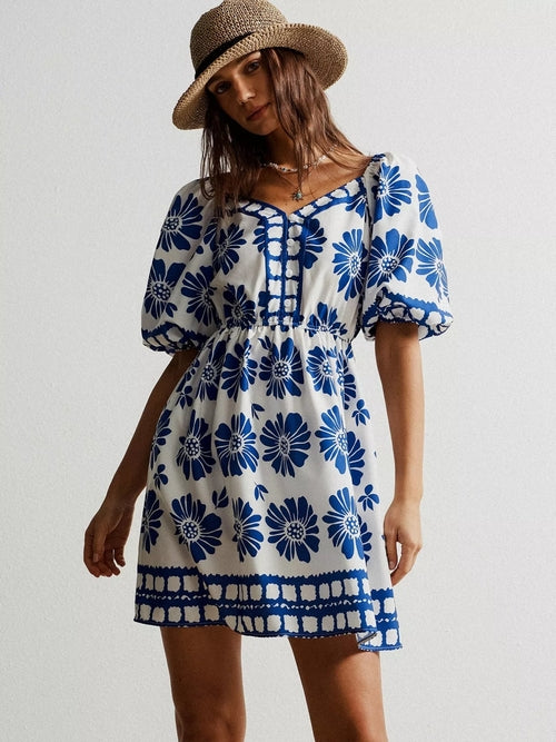 Floral print puff sleeve mini dress by Pear Daisy, featuring a vibrant floral pattern and feminine puff sleeves.