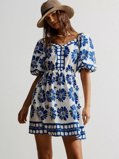 Floral print puff sleeve mini dress by Pear Daisy, featuring a vibrant floral pattern and feminine puff sleeves.