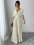 Carmine Juneberry pleated wrap-style maxi dress in 25th edition, featuring flowing fabric and elegant design.