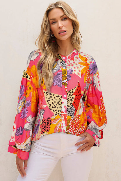 Red abstract floral print blouse by Carmine Juneberry featuring ruffled bubble sleeves and buttoned front, perfect for stylish tops.