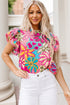 Colorful floral print Carmine Juneberry blouse with ruffle sleeves, vibrant trim, and lightweight fabric, perfect for casual wear.