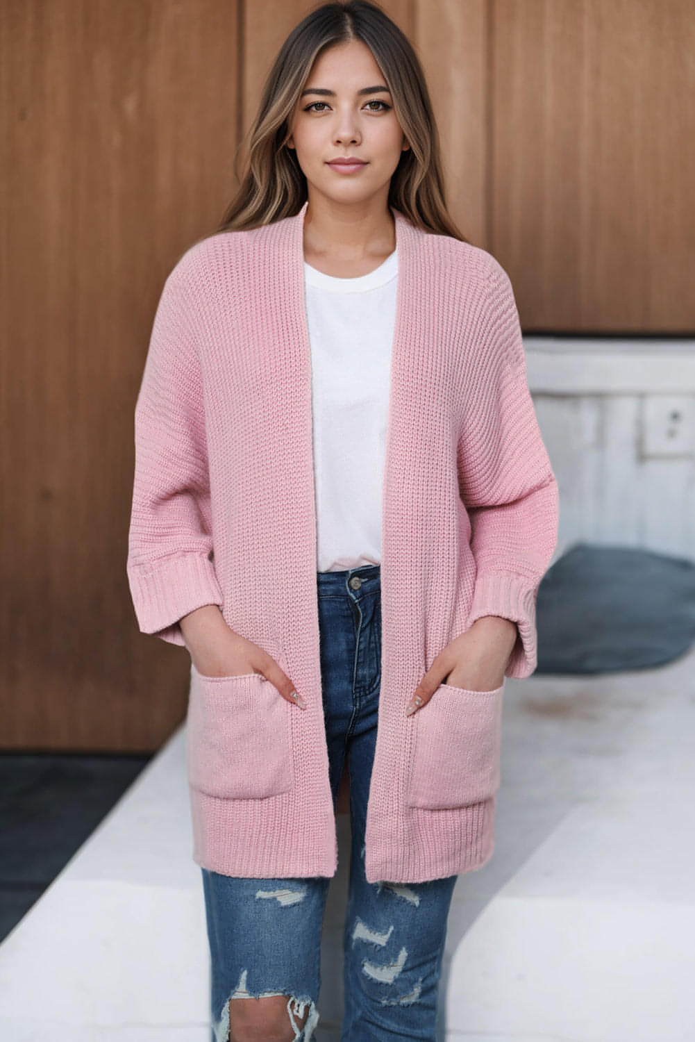 Pink oversized fold-over sleeve open-front cardigan by Carmine Juneberry, showcasing soft knit fabric and relaxed fit.