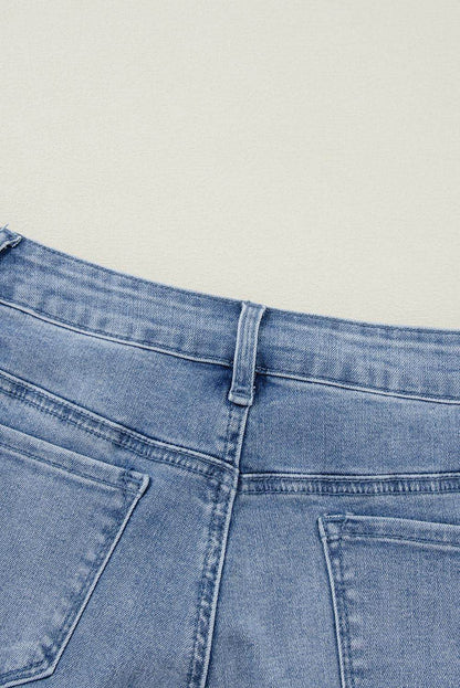 Carmine Juneberry Ashleigh Blue acid wash distressed wide leg high waist jeans on a model showing the relaxed fit and distressed details.