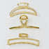 Set of three gold hair claw clips from Fuchsia Hercules, featuring sleek and elegant jewelry hair accessories.