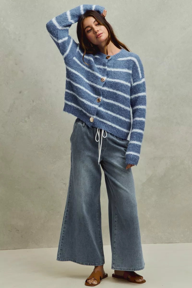 Pear Daisy SO ME Mid Rise Elastic Waist Flare Denim Jeans laid flat, showing classic blue denim with high waist and flared leg style.