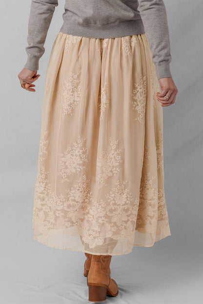 Solid embroidered mesh overlay midi skirt for women by Byzantium Bay, featuring intricate embroidery and a flowing silhouette.