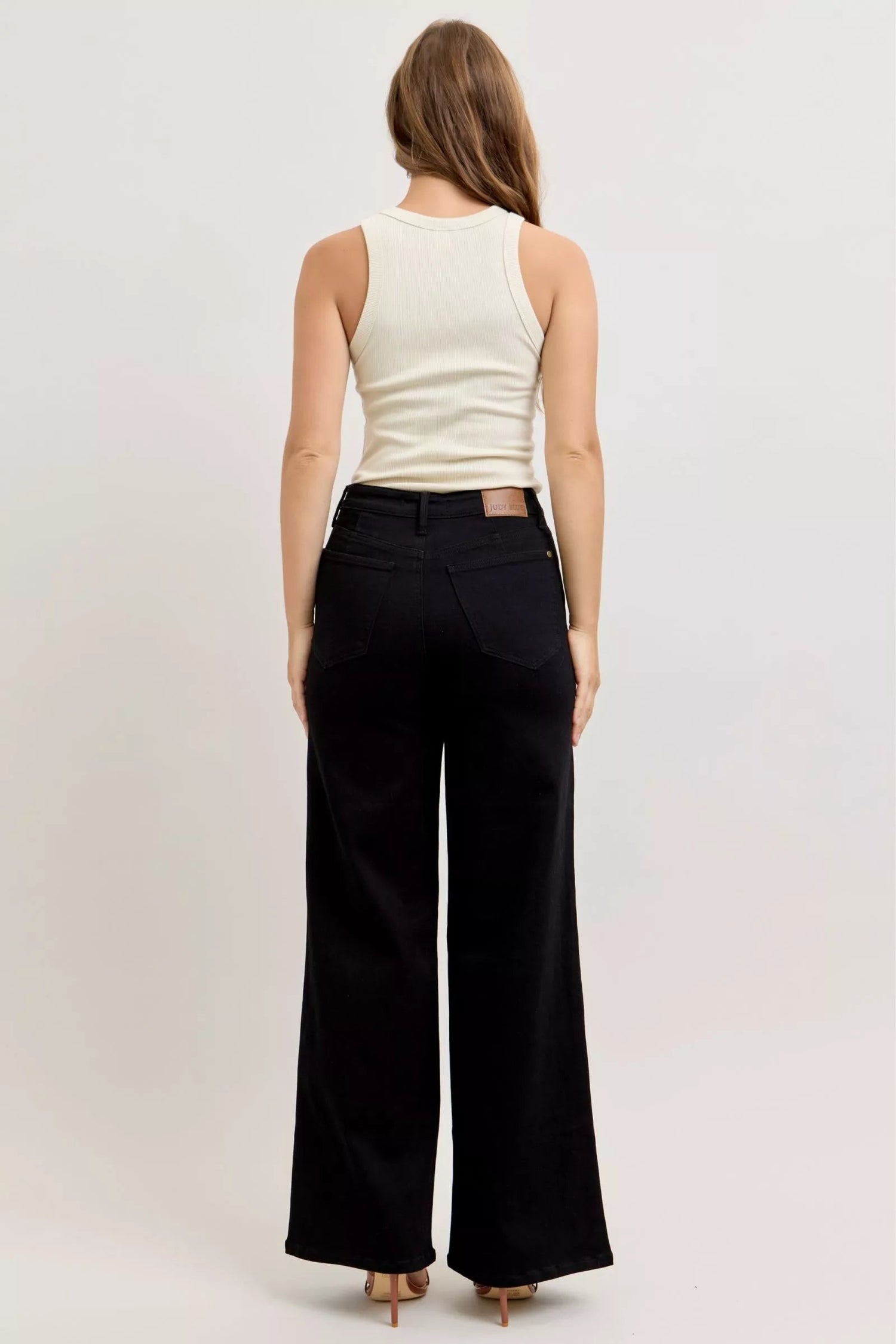 Pear Daisy Judy Blue high-waisted wide-leg jeans displayed on a model, showcasing relaxed fit and stylish denim design.