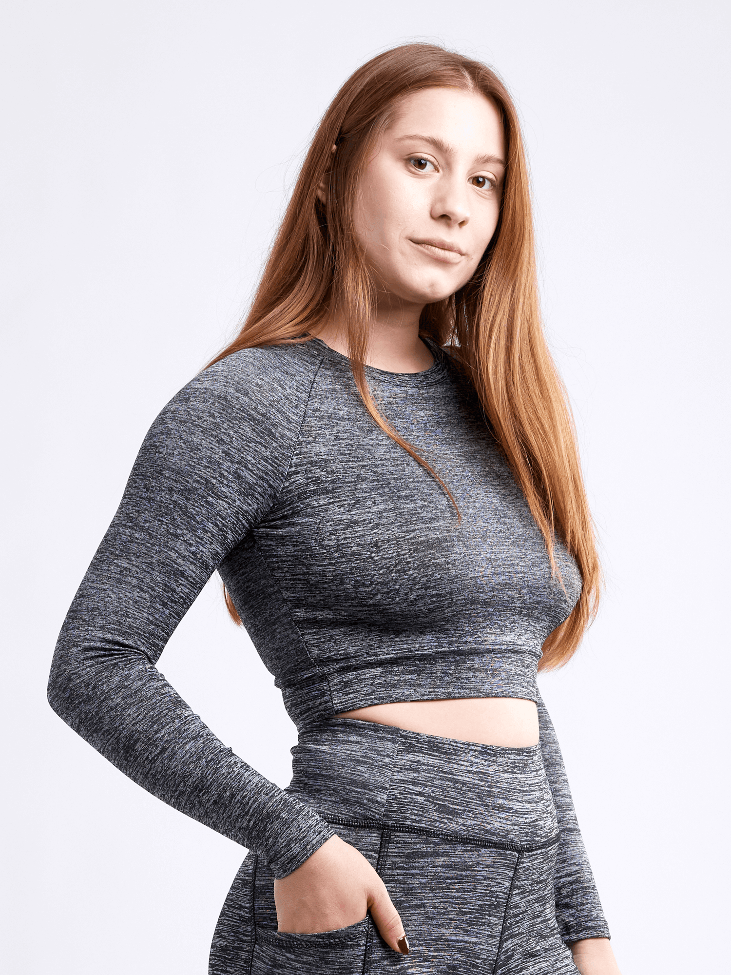 Black Lavender JupiterGear long-sleeve crop top, activewear with a fitted style, shown on a model in a gym setting.