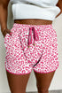 Pink leopard print casual shorts with elastic waistband, lace-up front, and contrast trim for women by Ruby Styx.