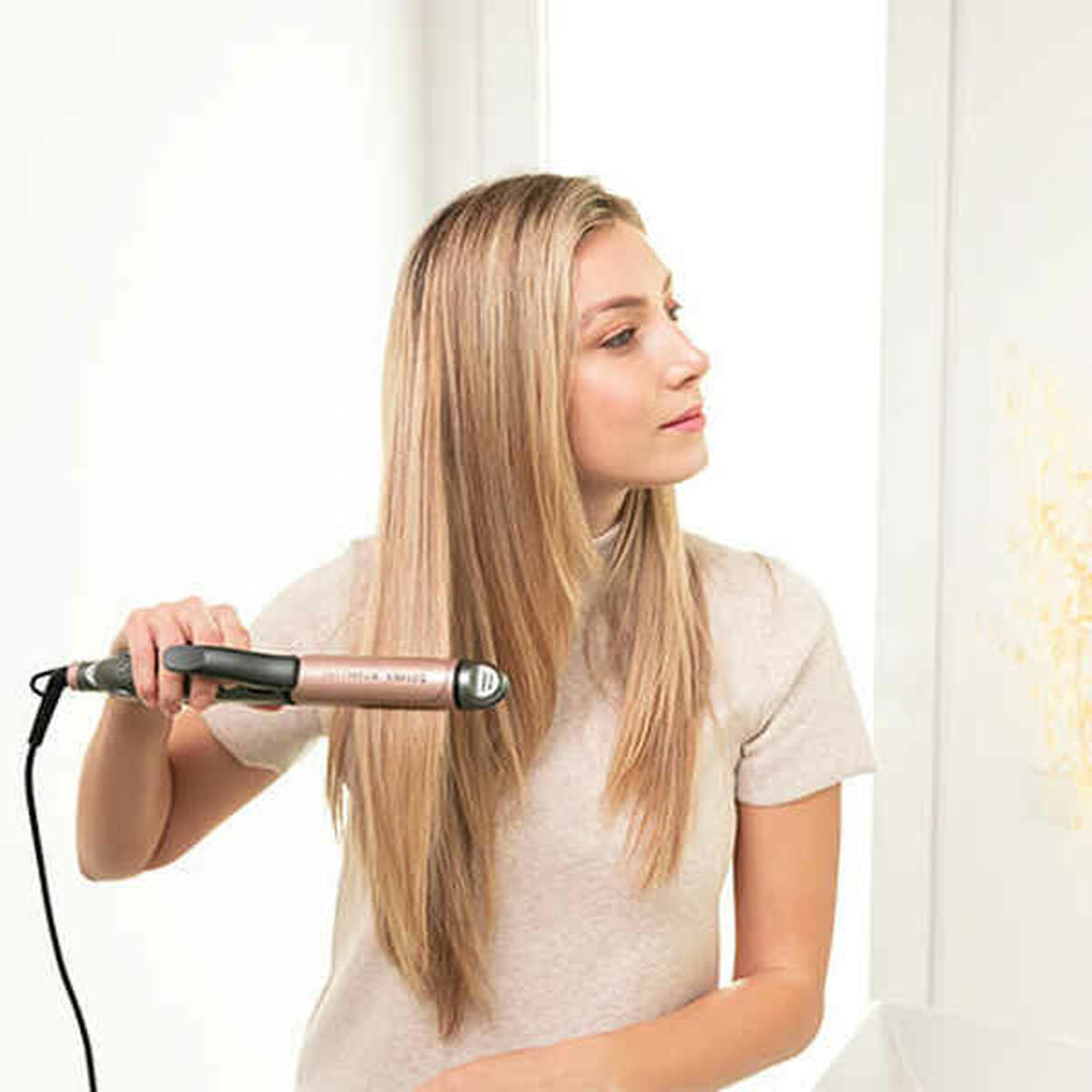 Ceramic hair straighteners by Bigbuy in black and pink, designed for smooth, straight hair styling.