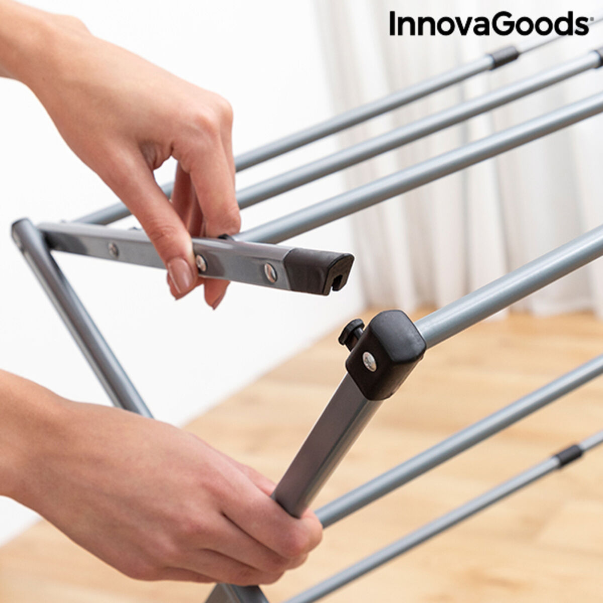 Extendable metal clothes dryer with three levels, folding design, suitable for home and garden laundry drying.