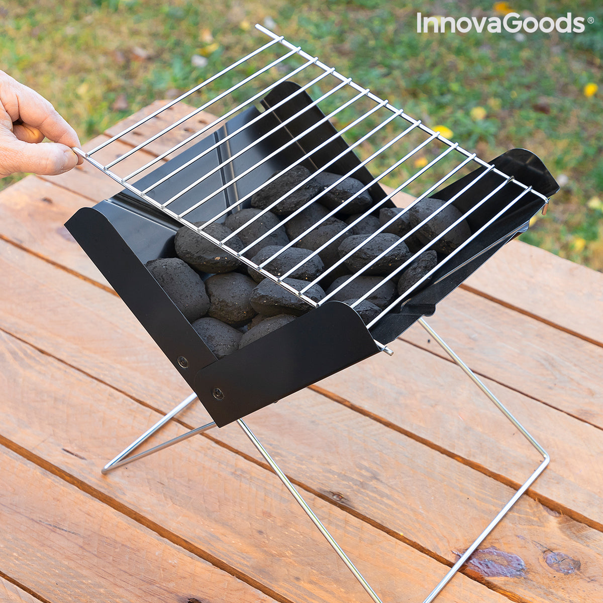 Mini folding portable charcoal barbecue from Bigbuy for garden use, featuring a compact design and foldable metal stand.