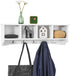White wall shelf coat rack from Carmine Deianeira with hooks for hanging coats and accessories in a home and garden setting.