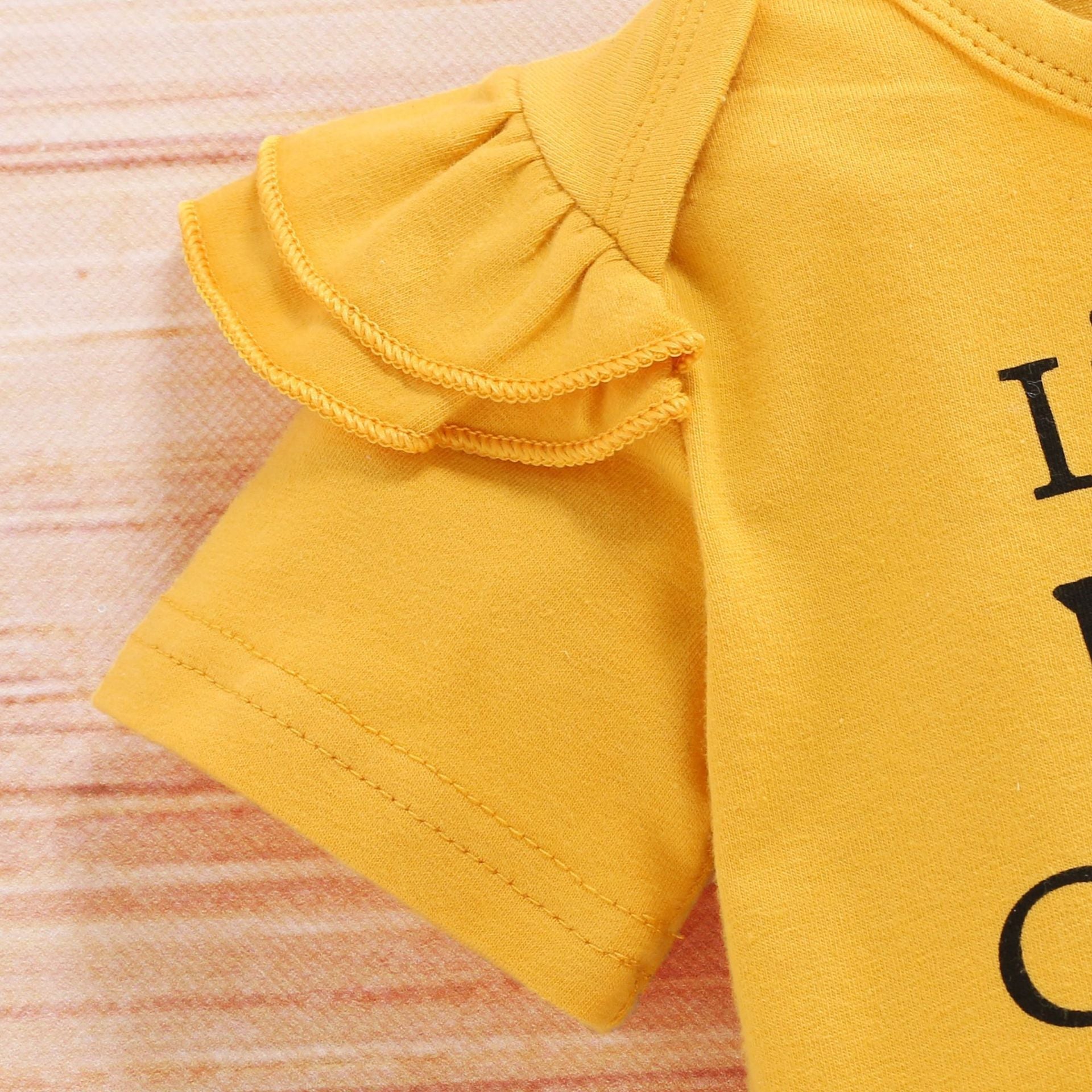 Three-piece baby girl sunflower outfit by Carmine Juneberry featuring a sunhat, dress, and bloomers for sunny days.