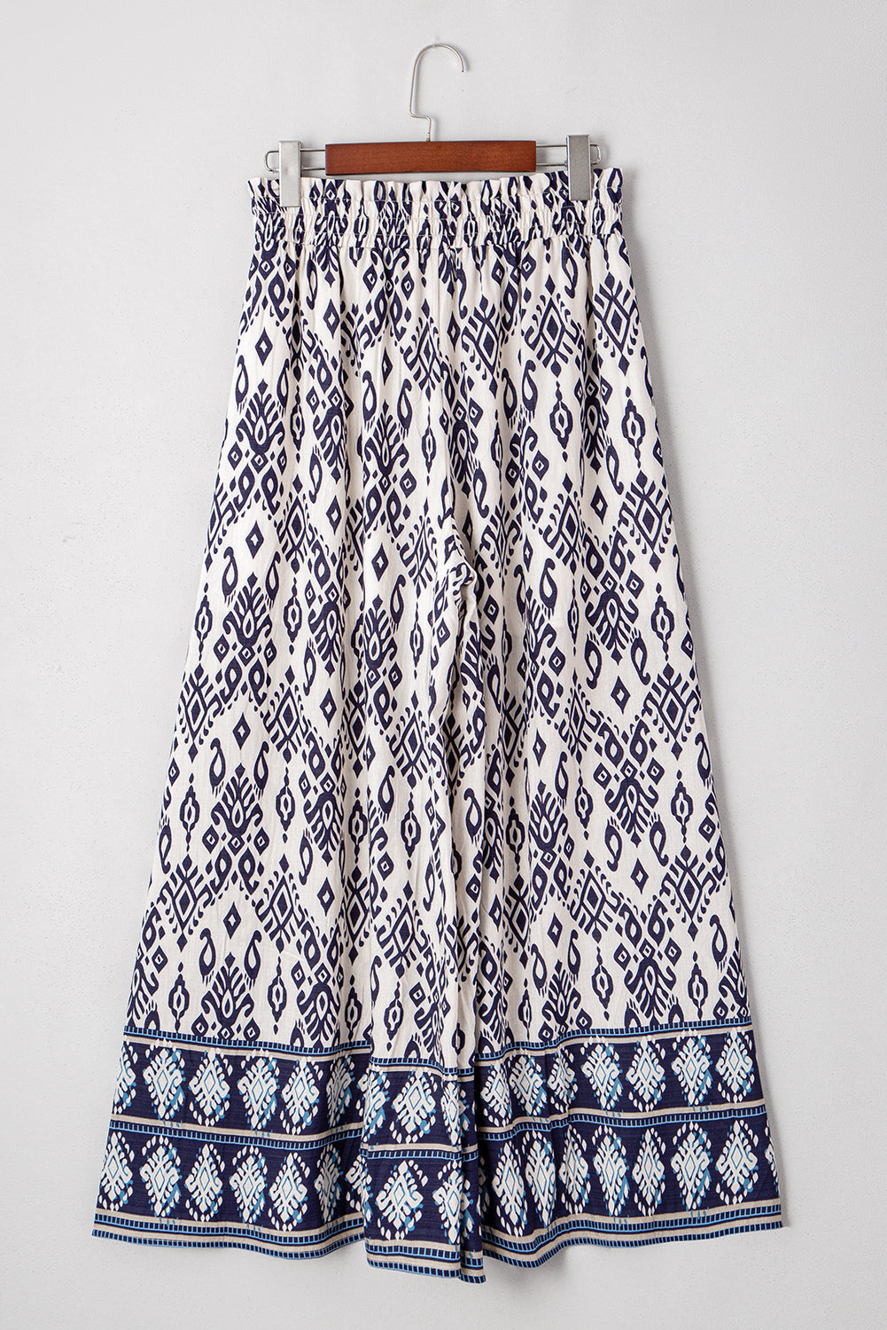 Women’s boho smocked high waist wide-leg pants by Byzantium Bay, featuring flowy fabric and relaxed fit.