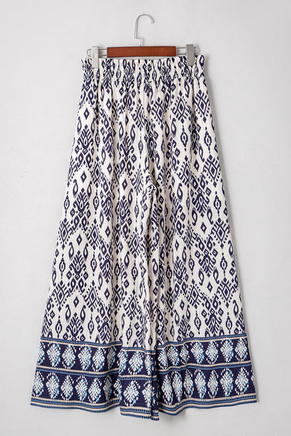 Women’s boho smocked high waist wide-leg pants by Byzantium Bay, featuring flowy fabric and relaxed fit.