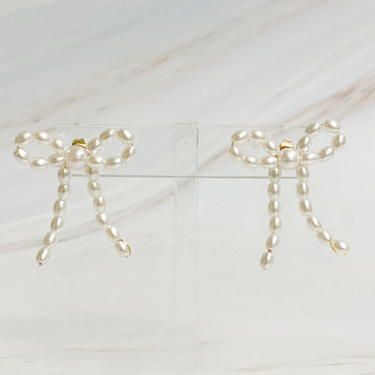 Fuchsia Hercules pearl bow ballerina earrings with delicate white pearls and gold-tone bow design, jewelry and watch accessory