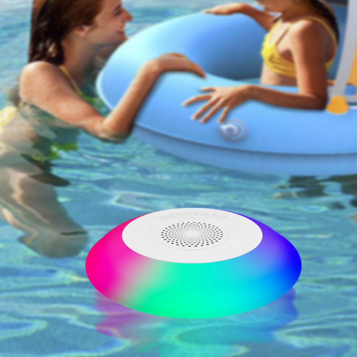 Salmon Lucky Floatilla Bluetooth waterproof speaker with LED lights, designed for pools and outdoor use, floating on water surface.