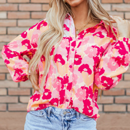 Pear Daisy floral print puff sleeve buttoned shirt with blooming flower pattern, displayed in a home and garden setting.