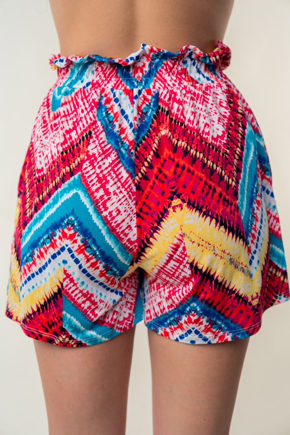 White Birch high-waisted printed shorts by Jade Icarus with automotive-themed design, displayed on a plain background.