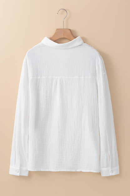 White floral lace splicing crinkled blouse from Carmine Juneberry, featuring hollow-out design and delicate lace details.