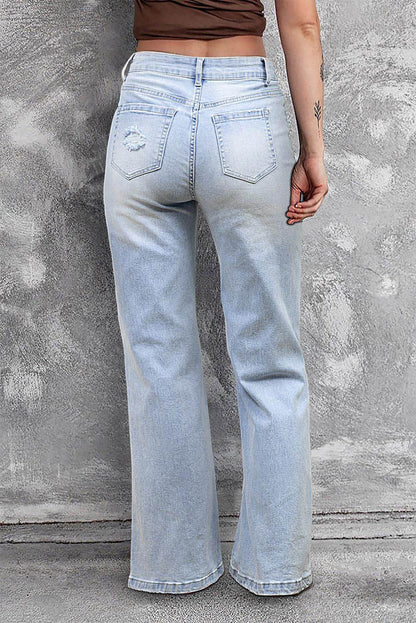 Carmine Juneberry Beau Blue vintage light wash distressed flare jeans with frayed hems and faded detailing, front view.