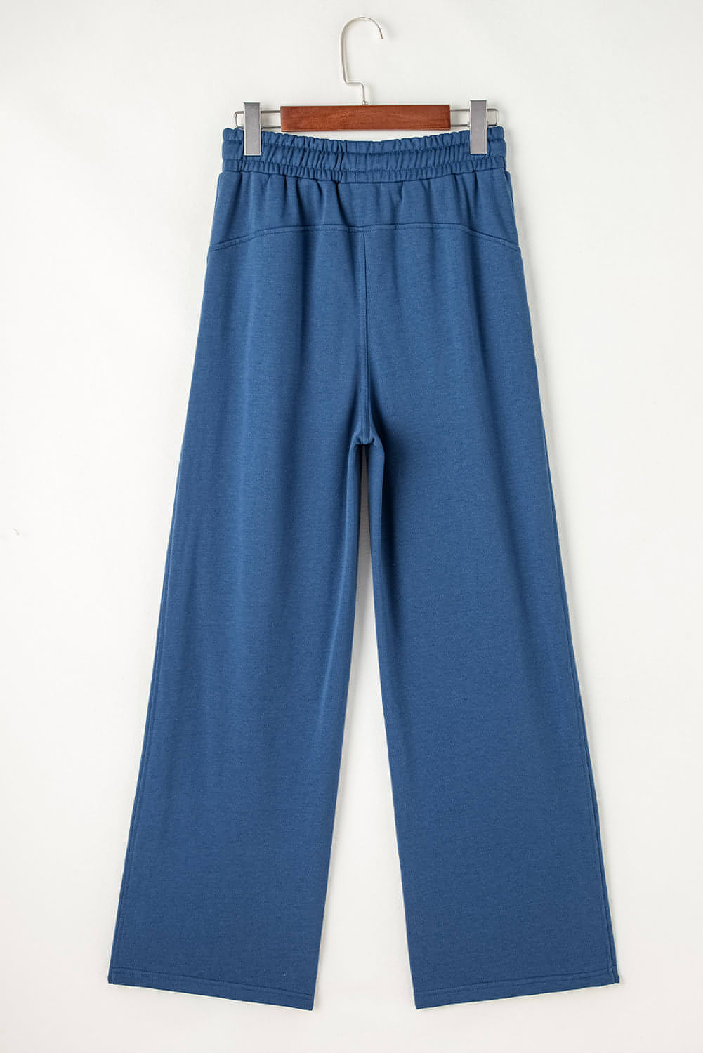 Carmine Juneberry Sail Blue high waist wide leg sweatpants with drawstring, pockets, and comfortable fabric, shown on a model.