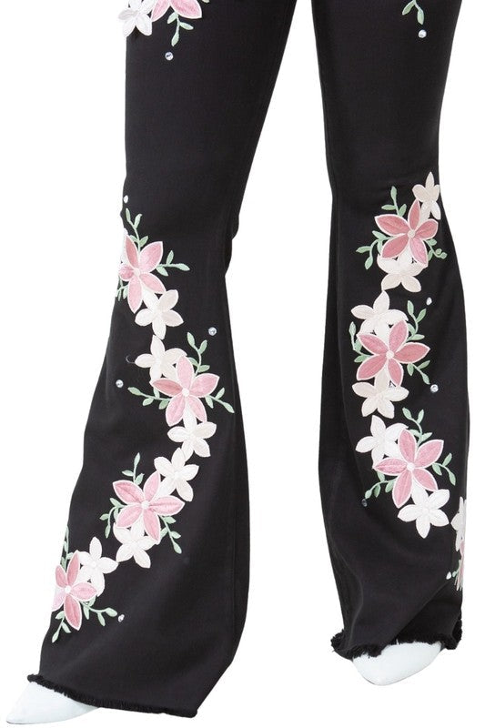 Jade Icarus Angela bell bottom jeans with 34-inch inseam, featuring retro style and fitted waist, displayed on a hanger.