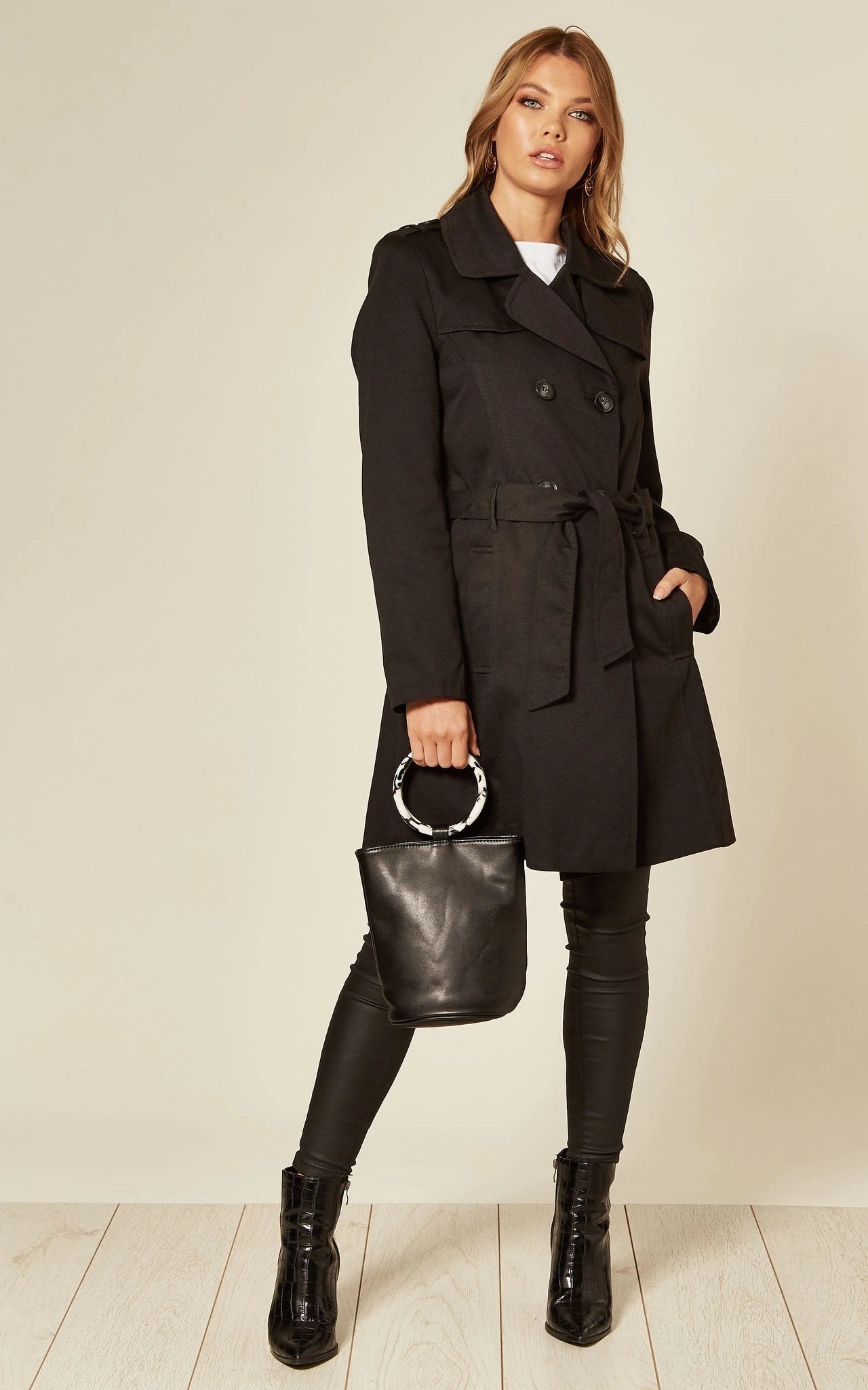 Black Rose Eleusis military double-breasted trench coat for spring and summer, shown on a hanger with front view.