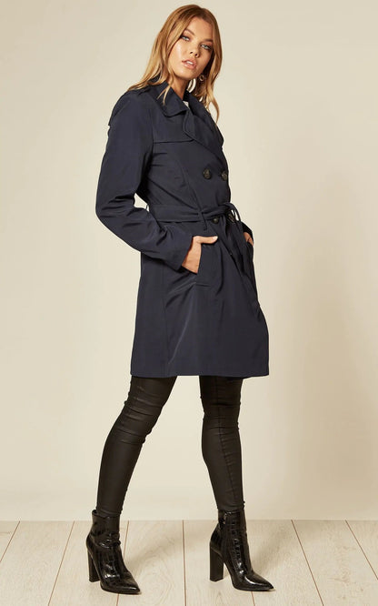 Navy spring/summer military double-breasted trench coat by Rose Eleusis displayed on a hanger with button details and classic design.
