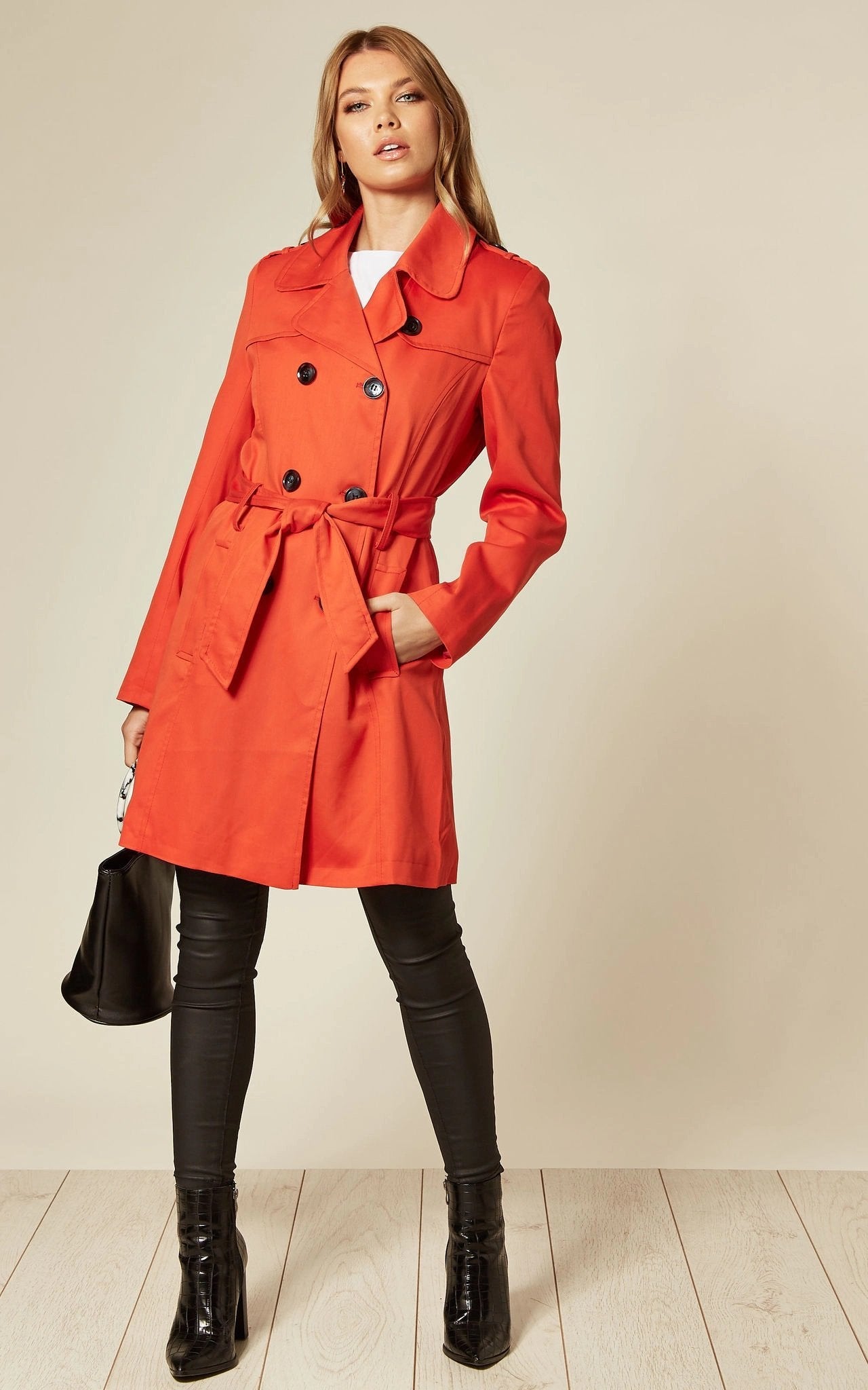 Rose Eleusis military-style double-breasted trench coat in spring and summer fabric, shown on a hanger.